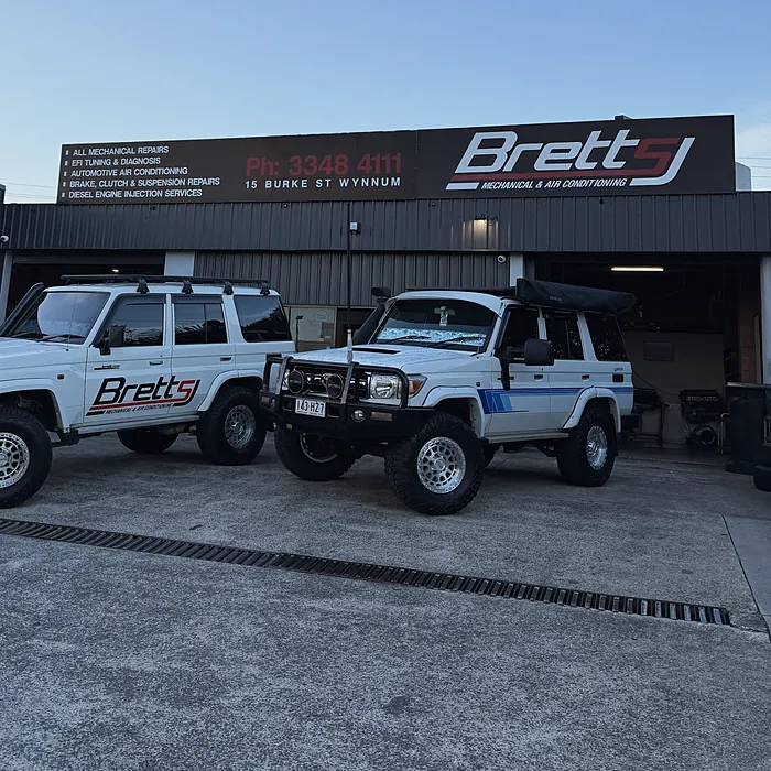 Brett’s branded LandCruisers out the front of the workshop
